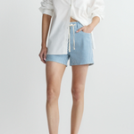 woman in white button down and drawstring stripe denim shorts on white background 