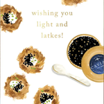 A white greeting card featuring watercolor-style caviar nests and the text 'wishing you light and latkes!' in gold. A small spoon and an open round tin of caviar are pictured beside the text, with a kraft envelope partially visible underneath.