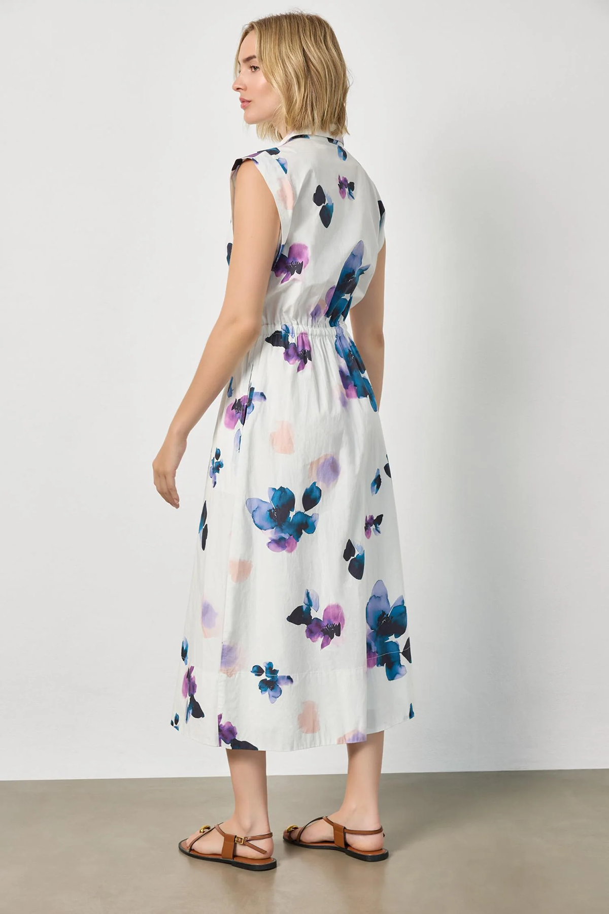 Woman wearing a floral dress with a plain background