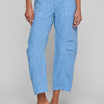 Light blue cargo pants worn by a person on a gray background