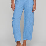 Light blue cargo pants worn by a person on a gray background
