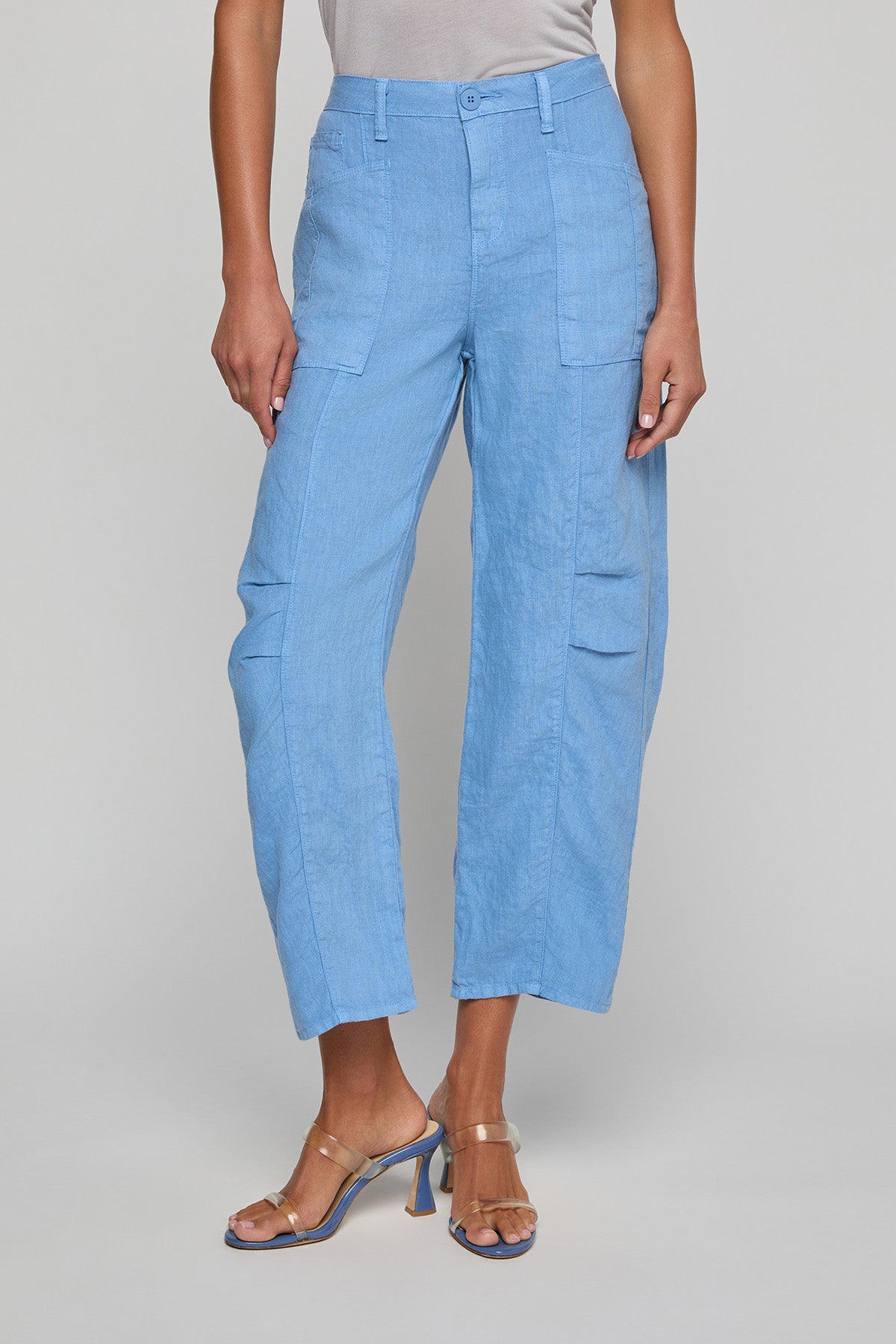 Light blue cargo pants worn by a person on a gray background