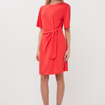 woman in red dress with knot detail 