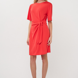 woman in red dress with knot detail 
