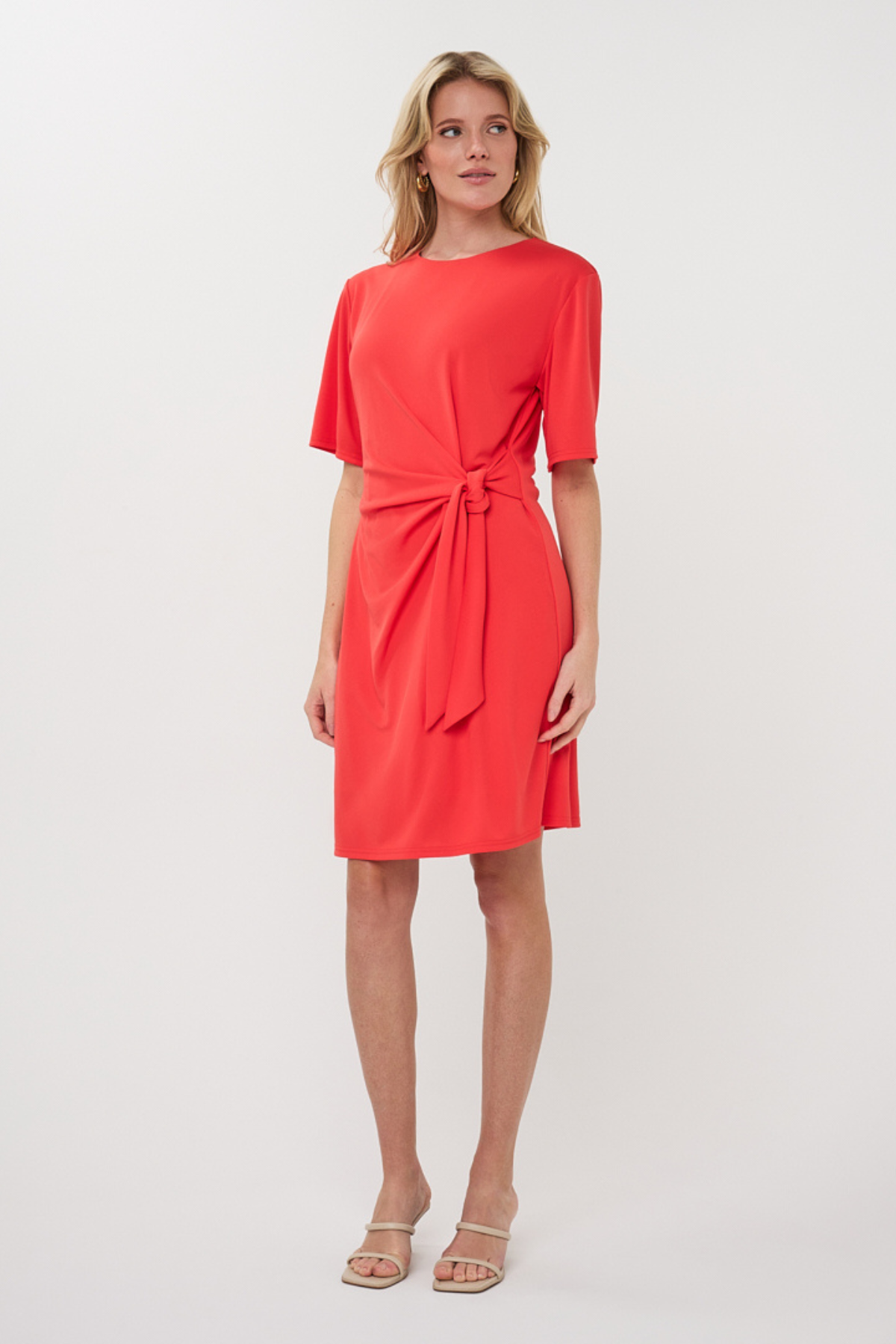 woman in red dress with knot detail 