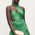 woman in green dress holding evening bag