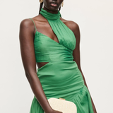 woman in green dress holding evening bag