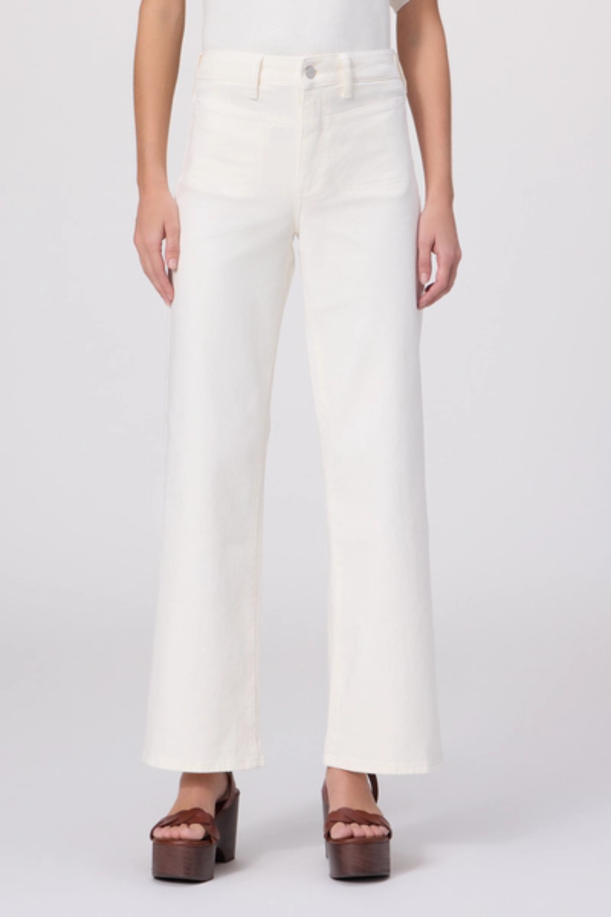 Person wearing white wide-leg pants on a plain background