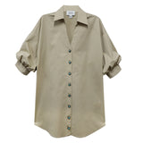 Beige shirt with rolled-up sleeves on a white background