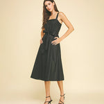 Black faux leather midi dress with button detailing.