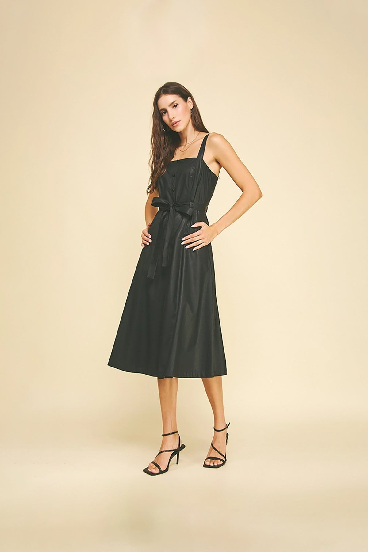 Black faux leather midi dress with button detailing.