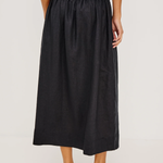 Person wearing a black skirt on a white background