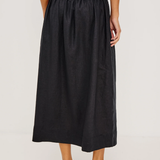 Person wearing a black skirt on a white background