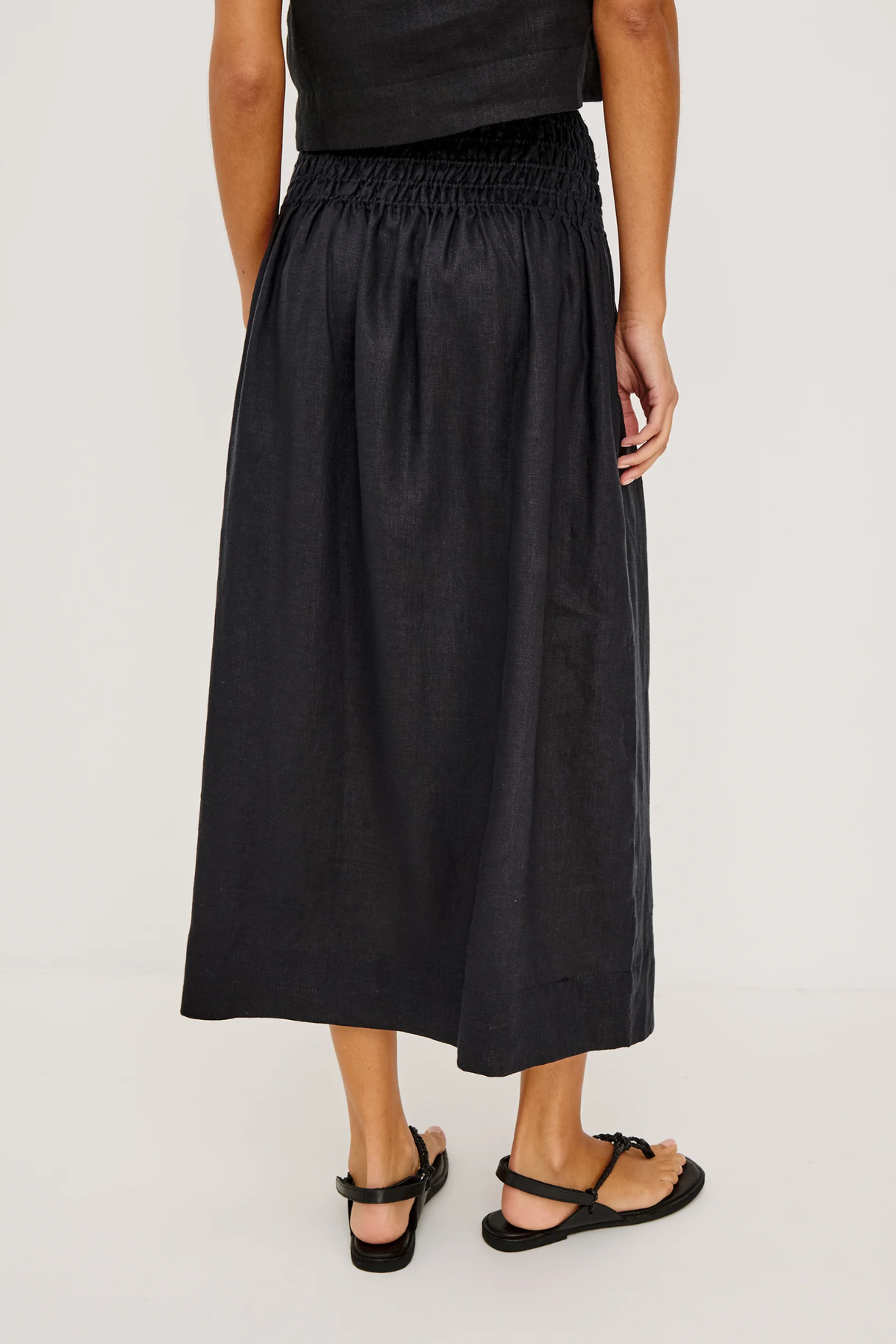 Person wearing a black skirt on a white background