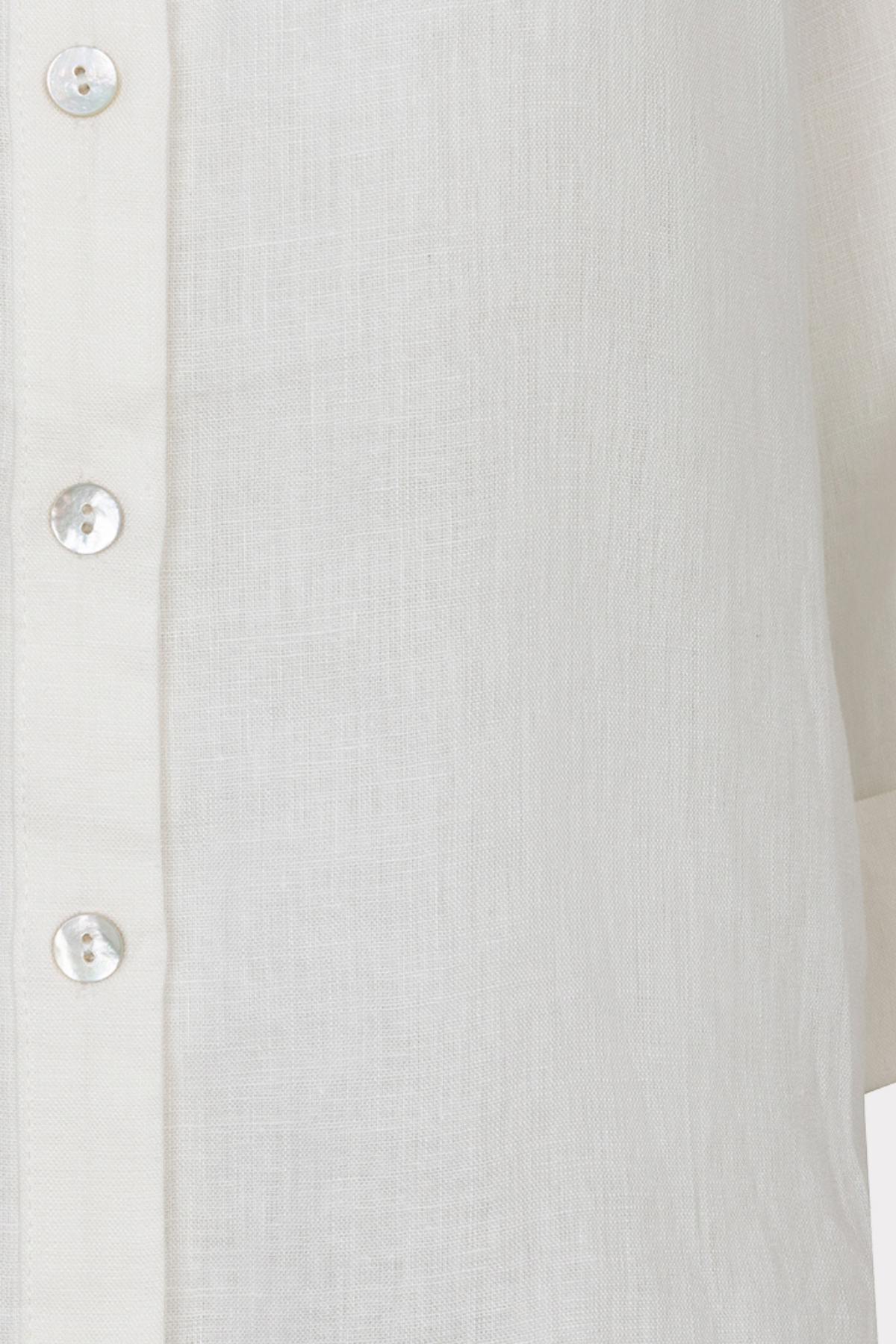 Close-up of a white button-up shirt with a blurred background