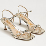 Pair of silver high-heeled sandals on a white background