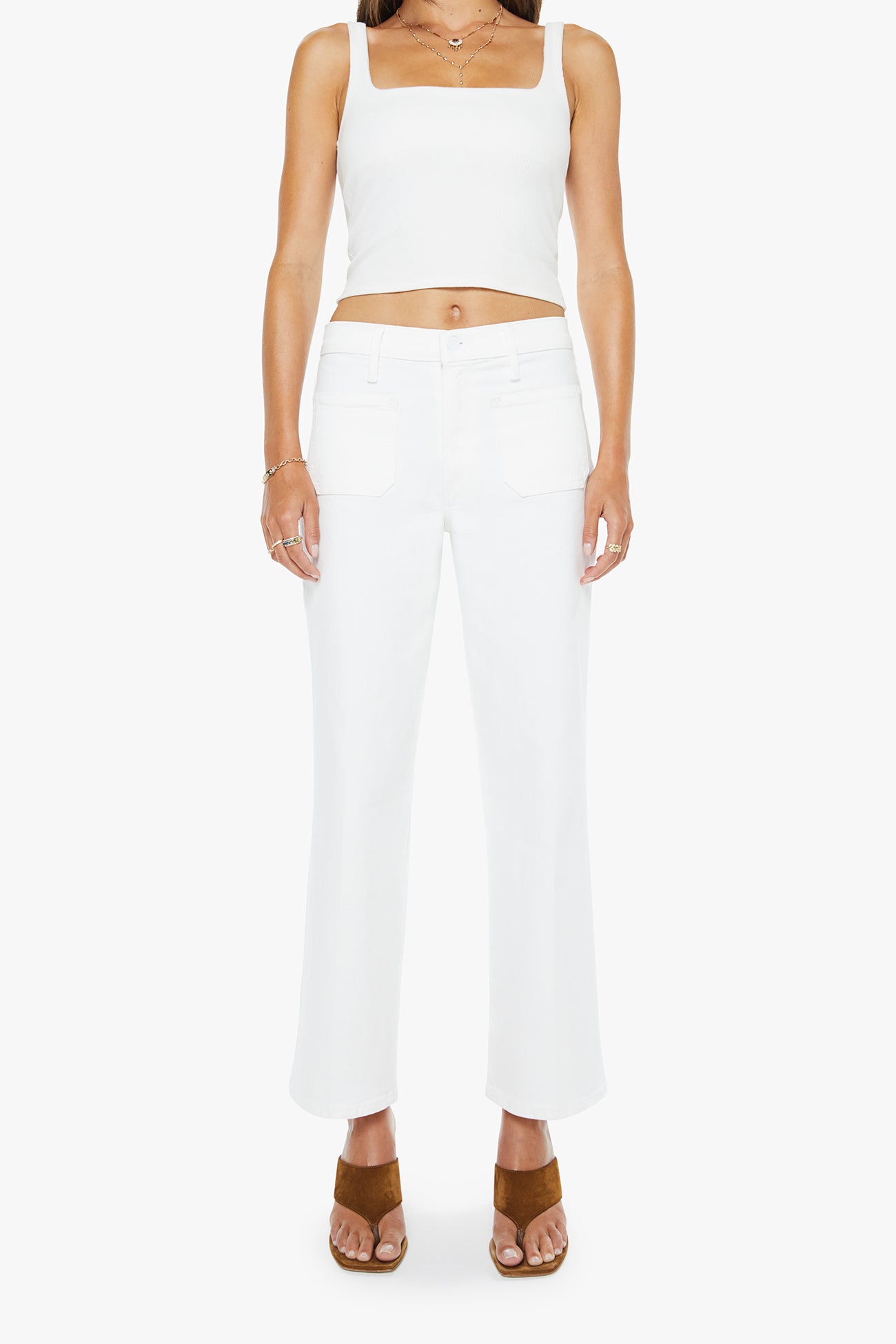 Person wearing a white sleeveless top and pants on a white background