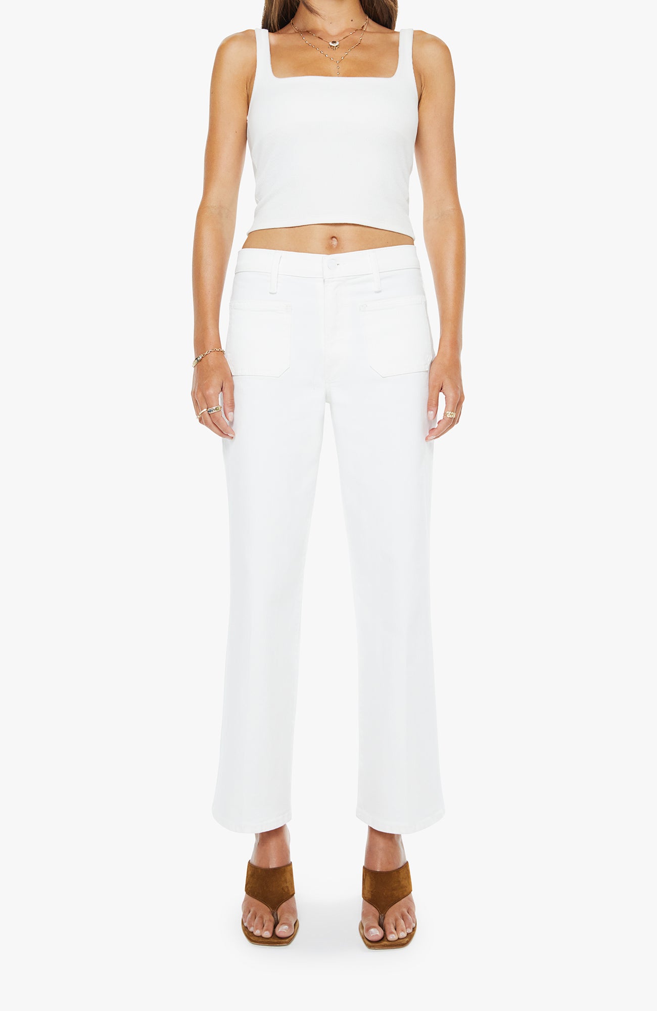 Person wearing a white sleeveless top and pants on a white background