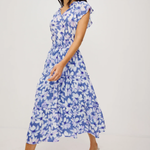 Woman wearing a blue floral dress on a white background