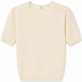 A cream-colored short-sleeve knit sweater with a textured, boucle-like pattern, displayed flat against a plain white background.