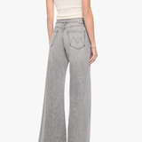 A woman shown from the back wearing light gray wide-leg denim jeans, a white ribbed tank top, and black heels against a plain white studio background.