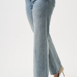 Light blue jeans worn by a person on a white background