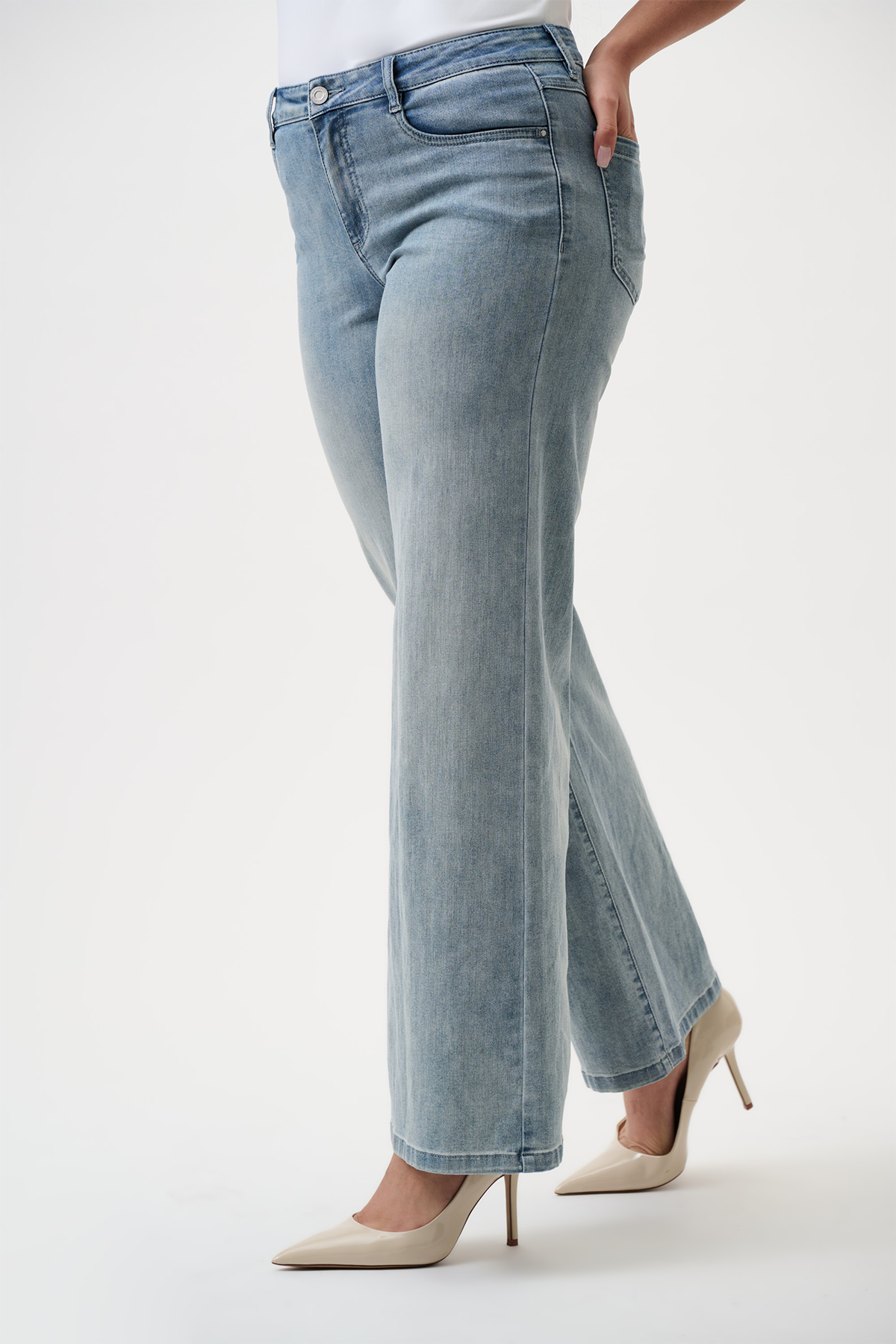 Light blue jeans worn by a person on a white background