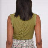 Model wearing an olive green sleeveless knit tank.