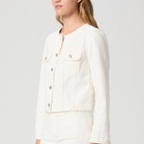 Woman wearing a white jacket on a plain background