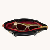 Black Hammitt Paul Mini crossbody bag worn with an evening outfit.