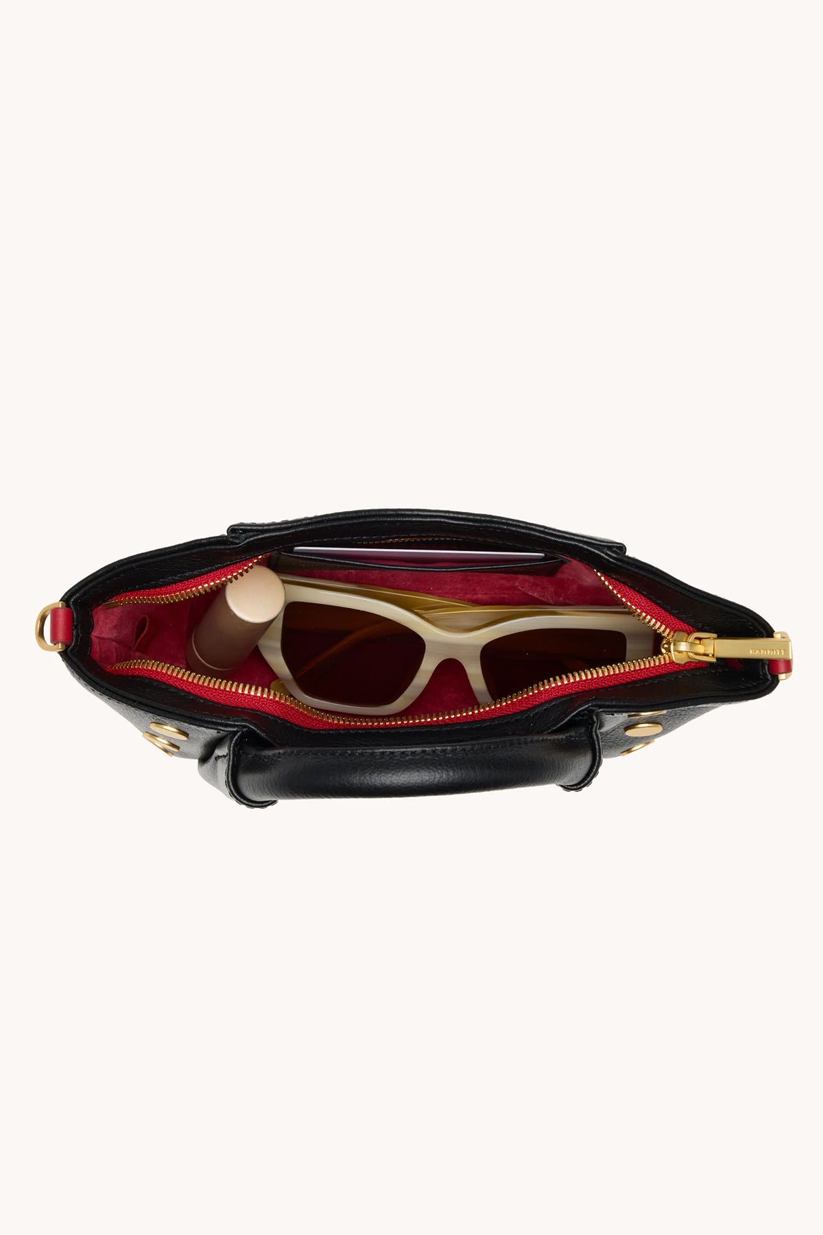 Black Hammitt Paul Mini crossbody bag worn with an evening outfit.