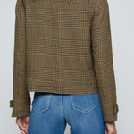Model wearing a printed trench jacket with jeans on an off white background.