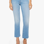 Light blue jeans worn by a person on a white background