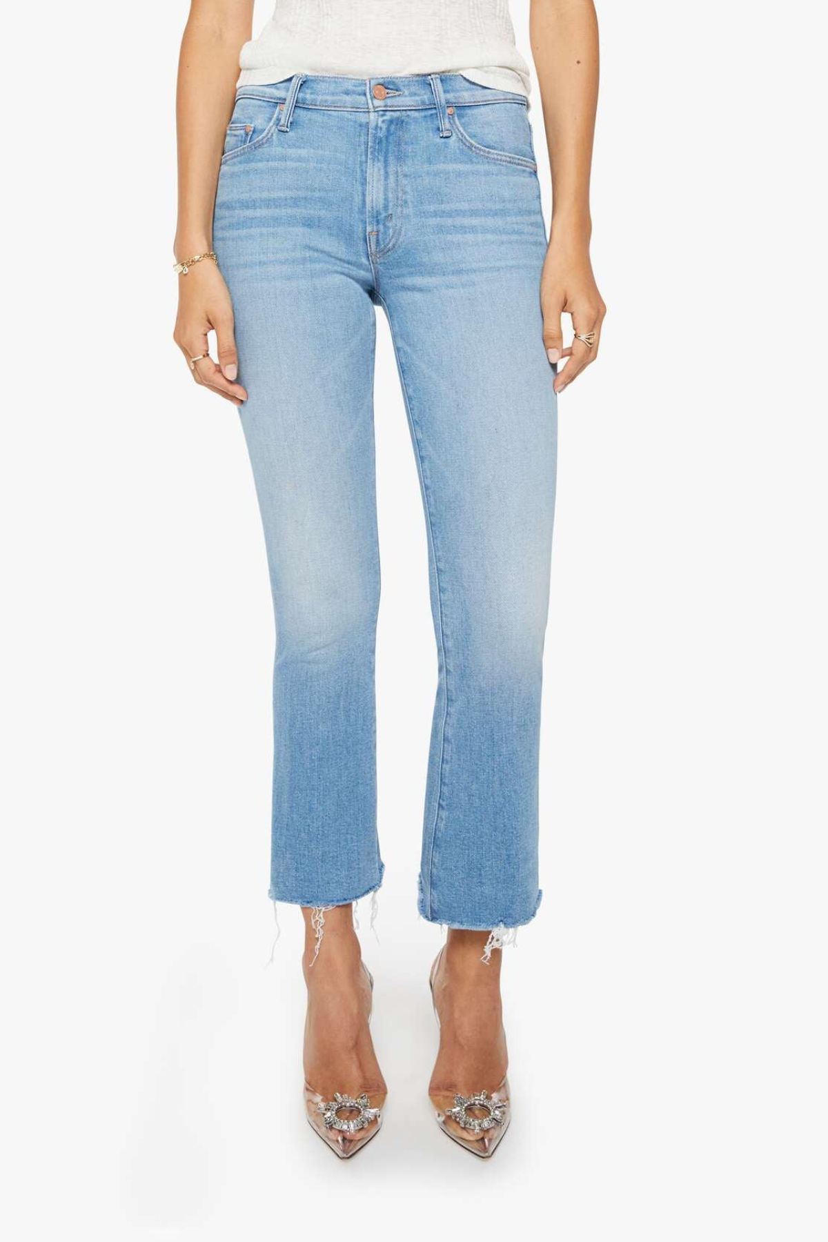 Light blue jeans worn by a person on a white background