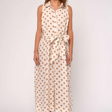 Woman wearing a sleeveless dress with a polka dot pattern on a white background