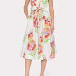 Woman wearing a sleeveless floral dress on a white background