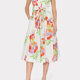 Woman wearing a sleeveless floral dress on a white background