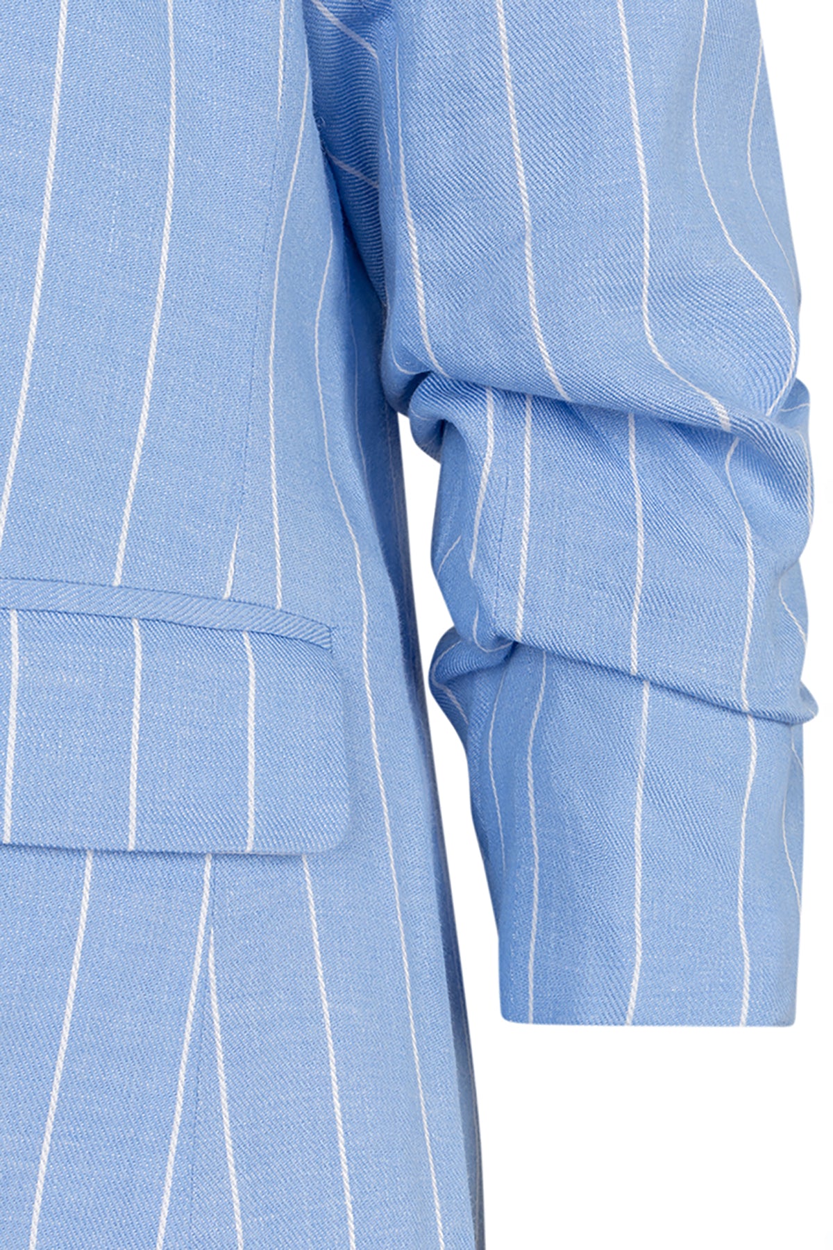 Close-up of a light blue pinstripe shirt with long sleeves on a white background