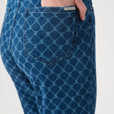 Blue patterned jeans with a visible brand tag on a white background