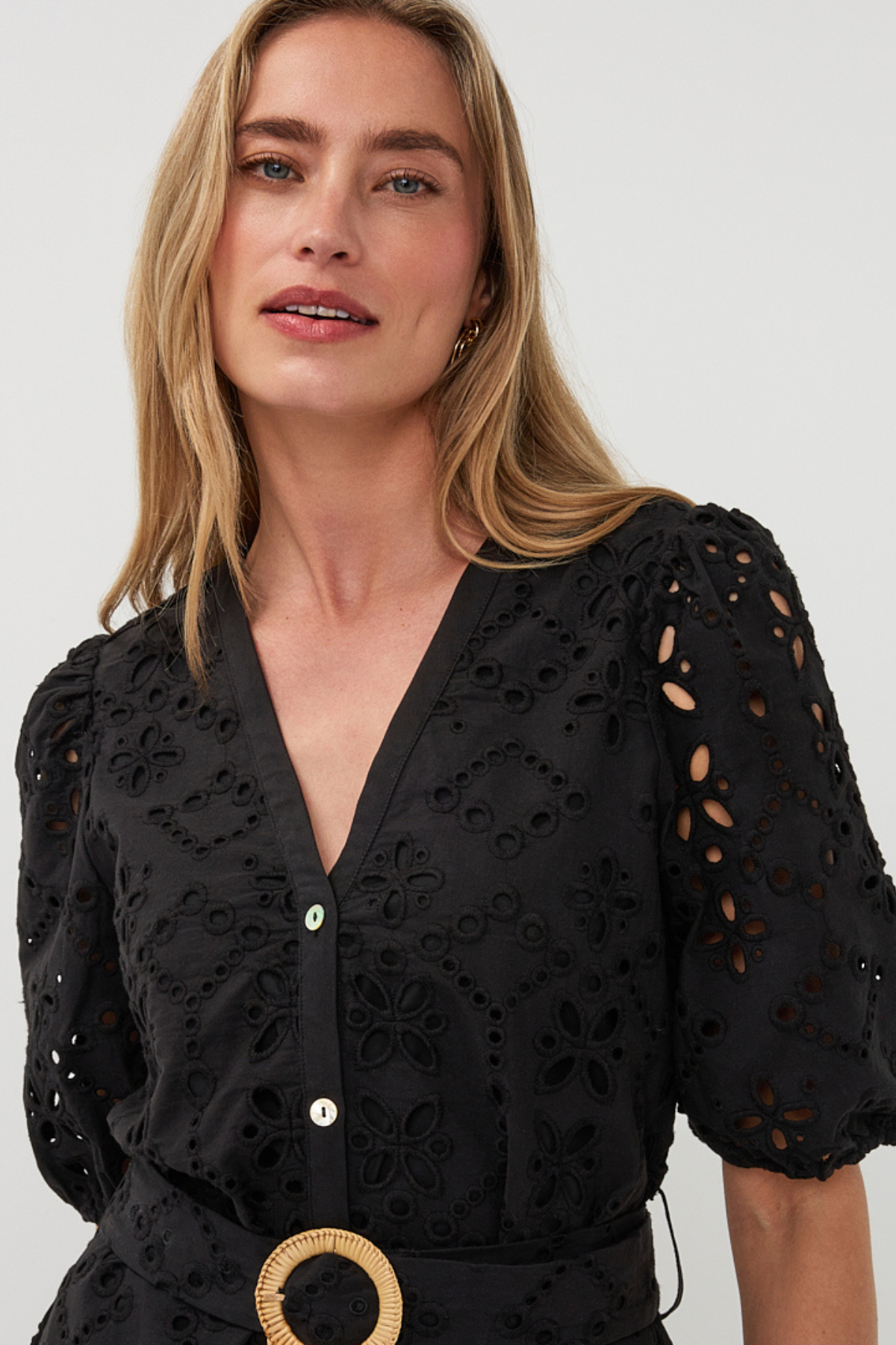 close up on woman in black dress on white background 