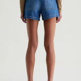 Person wearing blue denim shorts on a white background