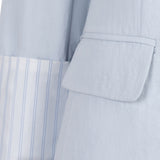Light blue suit jacket with striped shirt collar on a white background