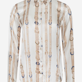 A long-sleeve button-up shirt with a vertical pattern of beige leather-like straps and buckles on a white background, shown on a light gray studio background.