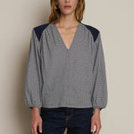 Neutral long-sleeve top styled casually with denim