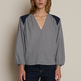 Neutral long-sleeve top styled casually with denim