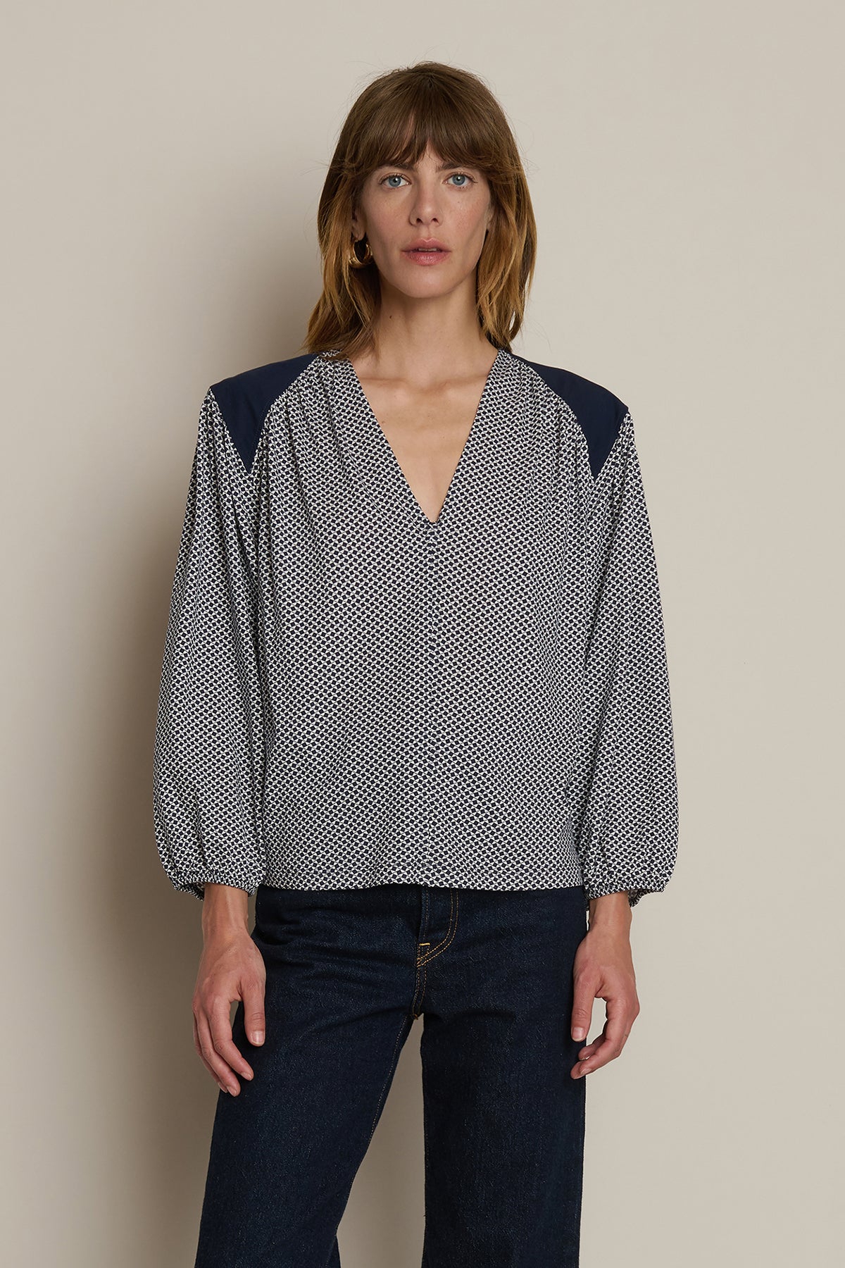 Neutral long-sleeve top styled casually with denim