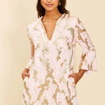Woman wearing a floral dress against a beige background