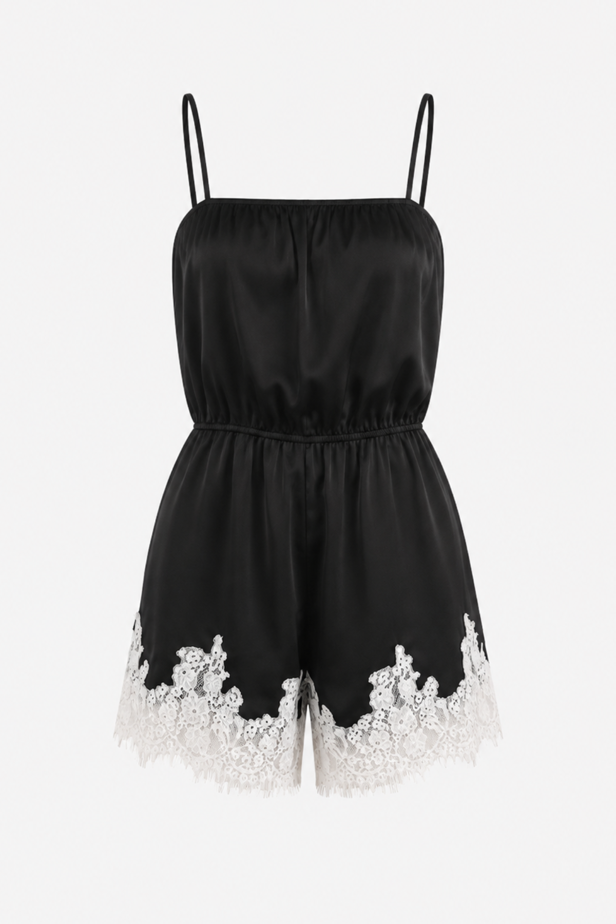 A black satin-like romper with thin shoulder straps, a gathered elastic waist, and white floral lace trim along the hem, shown on a plain light background.