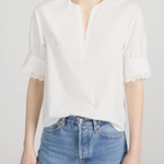 Model wearing Ivory popover blouse with a relaxed fit and clean minimalist styling.