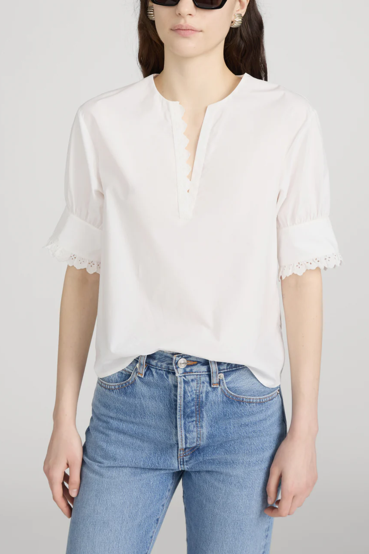 Model wearing Ivory popover blouse with a relaxed fit and clean minimalist styling.